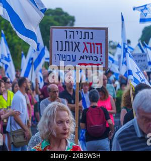 Haïfa, Israël - 08 juin 2024 : foule de personnes avec divers signes et drapeaux dans une Assemblée protester contre le gouvernement, appelant à de nouvelles élections. Banque D'Images