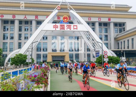 Pékin, Chine. 11 juin 2024. Les coureurs s'affrontent lors d'une course cycliste internationale le long d'une route traversant la zone frontalière entre le comté chinois de Hekou et la province vietnamienne de Lao Cai le 10 décembre 2023. Crédit : Xinhua/Alamy Live News Banque D'Images