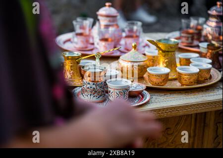 Souvenir traditionnel fait à la main de Bosnie-Herzégovine - cafetière turque avec de petites tasses en cuivre. Café bosniaque dans le bazar. Banque D'Images