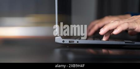 Gros plan des mains de l'homme d'affaires tapant sur l'ordinateur portable sur la table en verre avec l'homme d'affaires de réflexion travaillant à l'aide d'un ordinateur portable surfant l'inter Banque D'Images