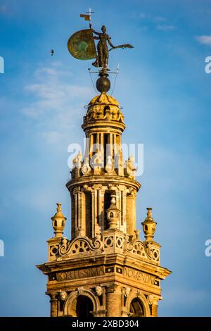 Gros plan de la statue de la foi au sommet de la Giralda, le clocher emblématique de Séville, en Espagne. Banque D'Images