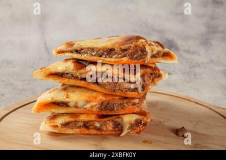 Pain plat naan pané de poulet farci coupé en morceaux triangulaires. Banque D'Images