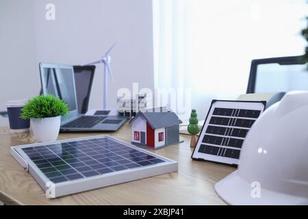 Les ingénieurs examinent les plans des architectes pour préparer l’installation de panneaux solaires et d’éoliennes sur le bâtiment afin de produire efficacement de l’électricité Banque D'Images