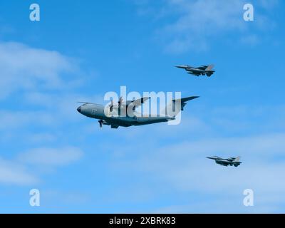 Normandie, France - 8 juin 2024 : Airbus A400M (CT-02) avion de transport militaire de l'armée de l'air belge aux côtés de deux chasseurs F16 à l'Arrom Banque D'Images