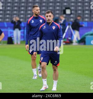 Berlin, Allemagne. 14 juin 2024. Josip Juranovic, croate, marche sur le terrain de l'Olympiastadion Berlin pendant la séance d'entraînement ouverte de l'équipe nationale de Croatie avant le match de l'UEFA EURO 2024 contre l'Espagne. Crédit : Oleksandr Prykhodko/Alamy Live News Banque D'Images