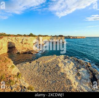 Picturesque seascape with cliffs, rocky arch and stacks (faraglioni), at Torre Sant Andrea in morning sunlight, Salento sea coast, Puglia, Italy Stock Photo