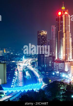 Illuminé par des lumières colorées, Saloma Link change de couleurs au hasard, avec le cimetière musulman au premier plan. Une autoroute et la rivière Klang courent par,Under Banque D'Images