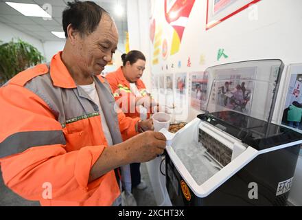 Tianjin, Chine. 17 juin 2024. Des travailleurs sanitaires prennent des glaçons à Tianjin, dans le nord de la Chine, le 17 juin 2024. Le Centre météorologique national de Chine a continué lundi après-midi à émettre une alerte jaune pour les températures élevées alors que plusieurs régions connaissent une chaleur étouffante. Crédit : Zhao Zishuo/Xinhua/Alamy Live News Banque D'Images