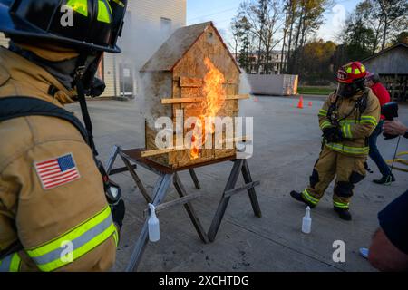 Citizens Fire Academy of Roswell Fire Department écoute l'instructeur capitaine Keith 'Doc' Schneider expliquer les avantages de l'utilisation d'un feu de maison de poupée p Banque D'Images