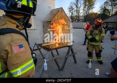 Citizens Fire Academy of Roswell Fire Department écoute l'instructeur capitaine Keith 'Doc' Schneider expliquer les avantages de l'utilisation d'un feu de maison de poupée p Banque D'Images