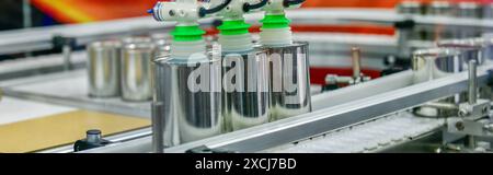 Produits alimentaires en conserve sur le tapis transporteur dans l'entrepôt de distribution. Concept du système de transport des colis Banque D'Images