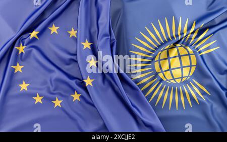 Drapeaux satinés de l'Union européenne et du Commonwealth des Nations couchés l'un sur l'autre. Rendu 3D. Banque D'Images