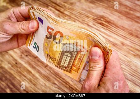Allemagne - 17 juin 2024 : billets dans la main. 50 billets en euros en paquet. Beaucoup de billets et d'argent. *** Geldscheine in der Hand. 50 Euro Banknoten als Bündel. Eine Menge an Banknoten und Geld. Banque D'Images