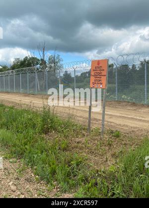 Karsava, Lettonie. 18 juin 2024. "Stop - State Border" est écrit en trois langues sur un panneau à la frontière lettone avec la Russie. Crédit : Alexander Welscher/dpa/Alamy Live News Banque D'Images