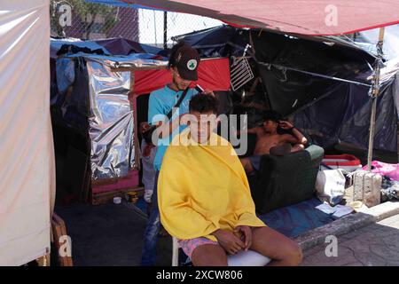 Mexico, Mexico, Mexique. 18 juin 2024. Deux Vénézuéliens se font couper les cheveux dans un camp pour migrants vénézuéliens arrivés à Mexico en cherchant à atteindre la frontière américaine. (Crédit image : © Luis E Salgado/ZUMA Press Wire) USAGE ÉDITORIAL SEULEMENT! Non destiné à UN USAGE commercial ! Banque D'Images