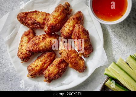 assiette d'ailes de poulet croustillantes fraîchement cuites sur la table grise, vue de dessus Banque D'Images