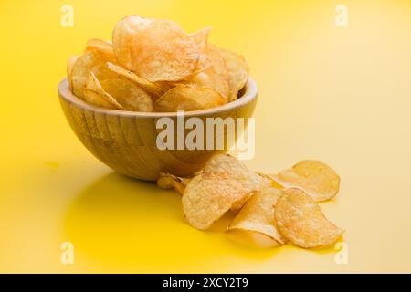 Un croustillant croustillant de pommes de terre dans un bol sur fond jaune Banque D'Images