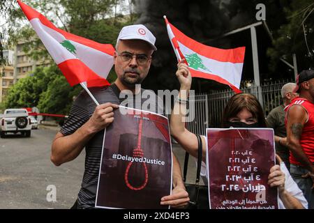 20 juin 2024, Beyrouth, Liban : les proches des victimes de l'explosion massive du port de Beyrouth le 05 août 2020 portent des pancartes exigeant justice devant des pneus en feu au palais judiciaire de Beyrouth lors d'une manifestation des familles des victimes de l'explosion. Moins de deux mois avant le 4ème anniversaire de l'explosion qui a tué plus de 200 personnes, presque tout reste inconnu de qui a ordonné l'expédition à pourquoi les autorités ont ignoré les avertissements répétés du danger. Les familles des victimes ont insisté pour obtenir des réponses, accusant les partis politiques d'entraver l'enquête locale. (Crédit image : © Banque D'Images