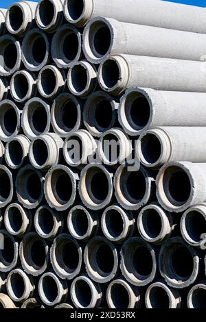 Tuyaux en béton empilés sur les terrains de l'usine. Banque D'Images