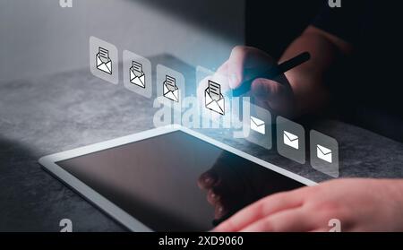 La femme utilise une tablette numérique avec une interface d'écran futuriste de mails. Communication et marketing numérique. Boîte de réception. Réception d'une alerte de message électronique. Banque D'Images