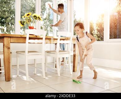 Nettoyage, père et fille dans la cuisine de la maison, balayage et lavage de la fenêtre, balai et collage. Maison, homme et enseignement de l'hygiène à l'enfant, fille Banque D'Images
