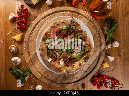 Pizza mortadelle avec fromage mozzarella et tomates séchées sur table en bois, vue de dessus Banque D'Images