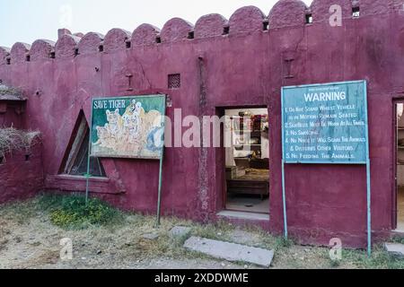 Panneau d'avertissement de comportement Safari et panneau de peinture « Save Tiger » délavé à l'entrée du parc national de Ranthambore, Rajasthan, dans le nord de l'Inde Banque D'Images