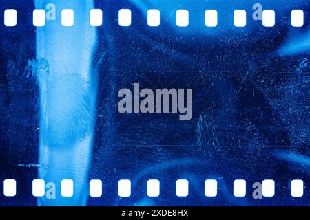 Texture ou surface poussiéreuse et rugueuse du film 35 mm.Film perforé rayé isolé sur fond blanc. Banque D'Images