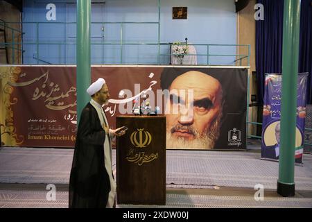 24 juin 2024, Téhéran, Iran : un religieux iranien passe devant un énorme portrait de Ruhollah Khomeini, le fondateur de la République islamique d'Iran et le principal leader de la Révolution iranienne, juste avant la réunion de campagne électorale du candidat réformiste iranien Masoud Pezeshkian pour l'élection présidentielle iranienne de juin 28 à Jamaran Hussainiya à Téhéran. Après l'accident d'hélicoptère qui a causé la mort du président Ebrahim Raisi et de sept autres personnes le 19 mai, l'Iran se prépare pour une élection à venir. Crédit : ZUMA Press, Inc/Alamy Live News Banque D'Images