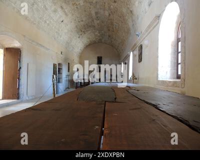 MONASTÈRE D'ARKADI, CRÈTE, GRÈCE . Une partie de l'ancien réfectoire, scène de la tragédie Arkadi de 1866, quand une révolution des habitants contre l'occupation turque a eu lieu. Une balle dans un arbre brûlé est un mémorial de l'époque où 36 moines et individus abritant ont été massacrés dans le réfectoire de l'abbaye.- ΜΟΝΑΣΤΉΡΙ ΑΡΚΆΔΙ, ΚΡΉΤΗ, Ελλάδα . Αναλόγιο, σκηνή της τραγωδίας/επανάστασης του 1866 στο Αρκάδι, όταν έγινε επανάσταση κατά της τουρκικής κατοχής. Μια σφαίρα σε ένα καμένο δέντρο στέκεται ως ανάμνηση της εποχής που 36 μοναχοί και άτομα που φιλοξενούνταν σφαγιάστηκαν στην τραπεζαρία της μονής. Banque D'Images