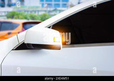 Clignotant sur le rétroviseur latéral de la voiture, le conducteur a allumé son clignotant pendant la conduite de la voiture, concept de conduite de voiture Banque D'Images