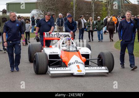 La McLaren MP4/2B 1985 de Niki Lauda roule à travers le paddock jusqu'à la zone d'attente pour sa course de démonstration. 2024 Goodwood, 81e réunion des membres, Sussex. Banque D'Images