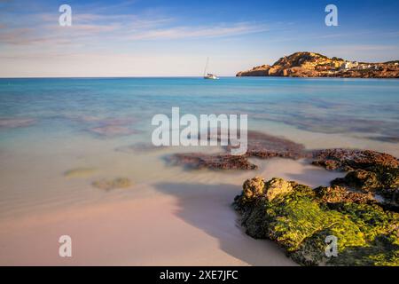 Vue sur la baie idyllique et la plage de Cala Agulla dans l'est de Majorque avec un voilier au premier plan Banque D'Images