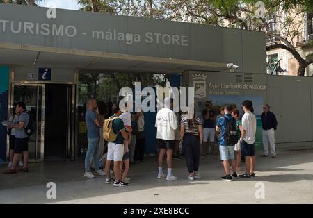 Un groupe de touristes est vu écouter un guide touristique devant un office de tourisme sur la place Plaza de la Marina, dans un contexte de rejet croissant du tourisme de masse. Malaga a connu une croissance significative du tourisme de masse et une augmentation du nombre d'appartements touristiques dans le centre-ville et les quartiers. Ces facteurs ont entraîné une hausse des prix des loyers et des logements. Les associations et organisations locales de voisinage demandent que des mesures soient prises pour limiter les prix des loyers et l'impact du tourisme de masse. Banque D'Images