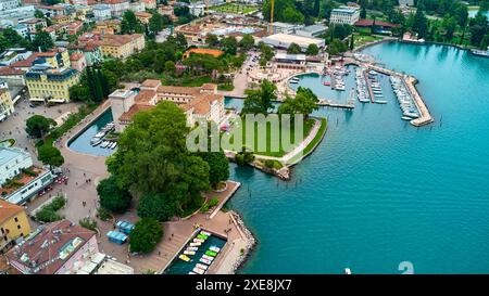 Riva del Garda, Lac de Garde, Italie - 25 juin 2024 : vue plongeante de Riva del Garada, avec le MAG Museo Alto Garda. Dans les douves entourées par les eaux du lac de Garde, une vue absolue. *** Riva del Garada aus der Vogelperspektive, mit dem MAG Museo Alto Garda. IM Wassergraben umringt vom Wasser des Gardasees, eine Absolute Sehenswürdigkeit. Banque D'Images