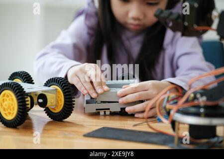 Concept d'éducation STEM. Jeune fille asiatique apprenant la conception de robot. Banque D'Images