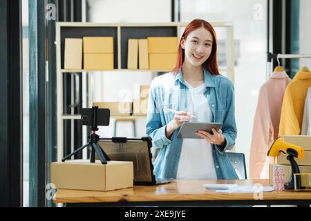 Entrepreneur de portrait de femme confiante à la mode de commerce électronique ou à l'entrepôt regardant la caméra. Banque D'Images