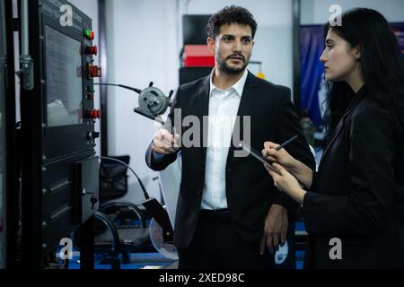 Homme d'affaires de l'inspection de l'industrie d'usine et de l'essai du bras de robots pour une utilisation dans les industries de fabrication complexes à grande échelle. Banque D'Images