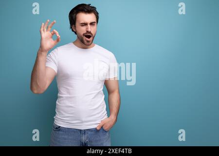 Élégant homme brune brutal dans un T-shirt blanc a eu un aperçu Banque D'Images
