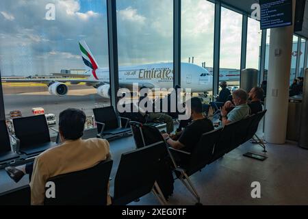 Passagers / vacanciers / hommes d'affaires attendant leur vol à la porte d'embarquement dans le terminal pour embarquer à bord de l'Airbus A380-800 Emirates à l'aéroport de Londres Heathrow Banque D'Images