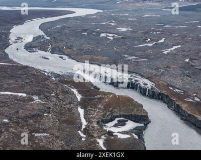 Vue aérienne d'une rivière avec de petites cascades dans le paysage islandais rocheux Banque D'Images