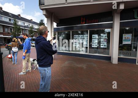 HAREN - een man maakt a rencontré zijn mobiele telefoon foon foto van de vernielde ruiten van een makelaarskantoor à Haren. Tijdens een UIT de hand gelopen Facebook-feest in de Groningse plaats werden massaal vernielingen aangericht en winkels geplunderd. ANP CATRINUS VAN DER VEEN Banque D'Images