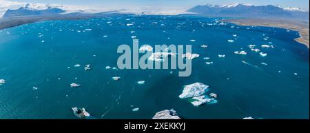 Vue aérienne des eaux bleues calmes avec des icebergs dans le paysage serein d'Islande Banque D'Images