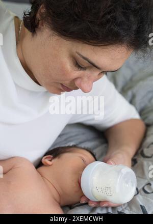 Une mère aimante prend soin de son nouveau-né. Maman nourrit son nouveau-né d'un biberon. Problèmes de l'allaitement maternel Banque D'Images