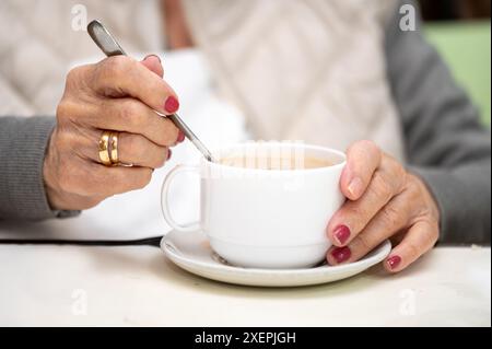 Gros plan d'une femme âgée appréciant le petit déjeuner. Photo de haute qualité Banque D'Images