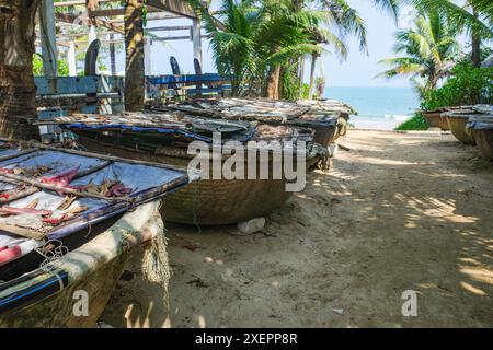 Hoi an, Vietnam - 5 février 2024 : bateaux de pêche traditionnels vietnamiens sur la plage d'an Bang, Hoi an Banque D'Images