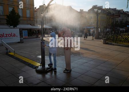Varsovie, Pologne. 28 juin 2024. Des femmes porteuses de foulards et de hijabs sont vues se rafraîchir dans une station de brumisation à Varsovie, en Pologne, le 28 juin 2024. (Photo de Jaap Arriens/Sipa USA) crédit : Sipa USA/Alamy Live News Banque D'Images
