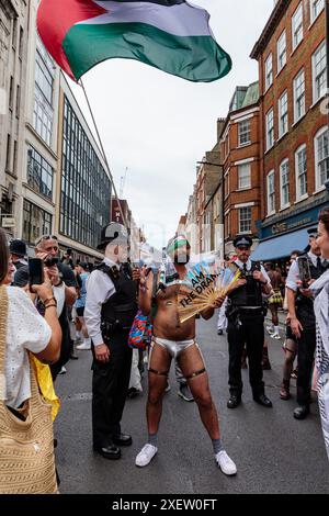 Soho, Londres, Royaume-Uni. 29 juin 2024. Le partisan de Pro Palestine est passé par la police alors qu'il tente de rejoindre le Jewish Pride Party. La plus grande association caritative LGBT juive de Grande-Bretagne a été forcée de se retirer de la London Pride cette année, car la Pride à Londres ne pouvait garantir la sécurité des manifestants juifs. C’est le plus grand événement de l’histoire du Royaume-Uni dont les Juifs ont été exclus. Plutôt que de permettre à la parade de la fierté de Londres d’être Judenrein (Juif Free), la communauté a organisé son propre « Jewish Pride Party » où juifs et non juifs, LGBTQ+ et hétérosexuels, ont pu célébrer la fierté ensemble. Crédit : Amanda Rose/Alamy Live News Banque D'Images