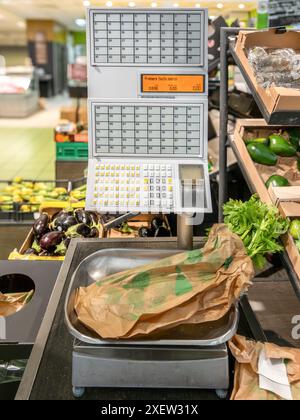 Balances avec touches numérotées pour peser et étiqueter vous-même les fruits et légumes au supermarché italien Banque D'Images