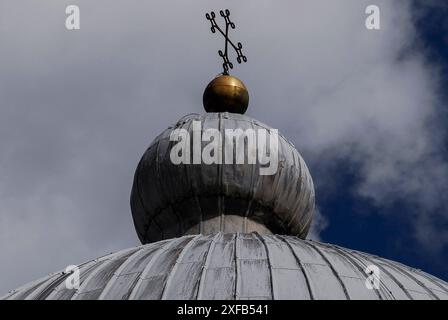 Les ressorts croisés de boule dorée surmontant le dôme gainé de plomb du Duomo di Santa Maria Assunta sur le Campo dei Miracoli à Pise, Toscane, Italie, le dôme est maintenant considéré comme ayant été construit de 1090 à 1100, peu de temps après la fondation de la cathédrale en 1064. Banque D'Images